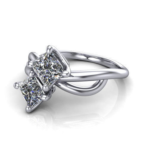 Mya princess three stone engagement ring in 18K White Gold, three-quarter perspective showing two brilliant princess-cut diamonds set diagonally on a polished infinity-loop shank