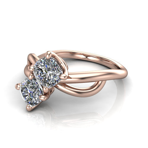 Mya cushion three stone engagement ring in 18K Rose Gold, three-quarter perspective showing two brilliant cushion-cut diamonds set diagonally on a polished infinity-loop shank