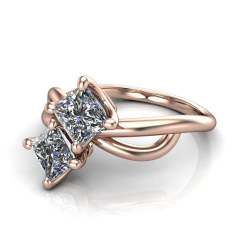 Mya princess three stone engagement ring in 14K Rose Gold, three-quarter perspective showing two brilliant princess-cut diamonds set diagonally on a polished infinity-loop shank