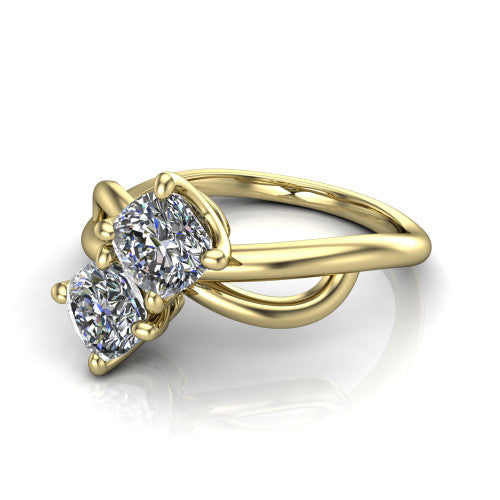 Mya cushion three stone engagement ring in 18K Yellow Gold, three-quarter perspective showing two brilliant cushion-cut diamonds set diagonally on a polished infinity-loop shank