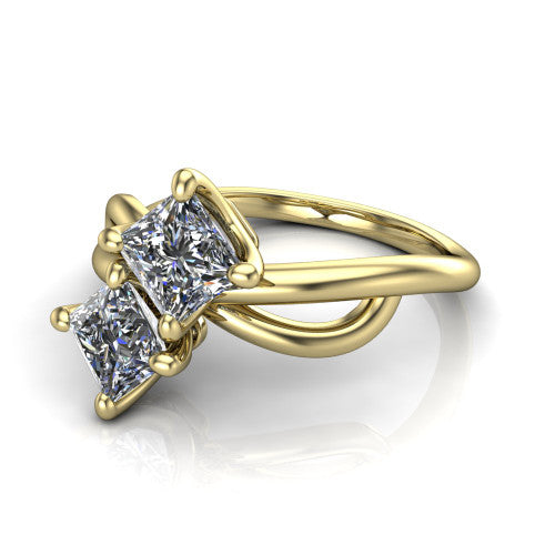Mya princess three stone engagement ring in 18K Yellow Gold, three-quarter perspective showing two brilliant princess-cut diamonds set diagonally on a polished infinity-loop shank