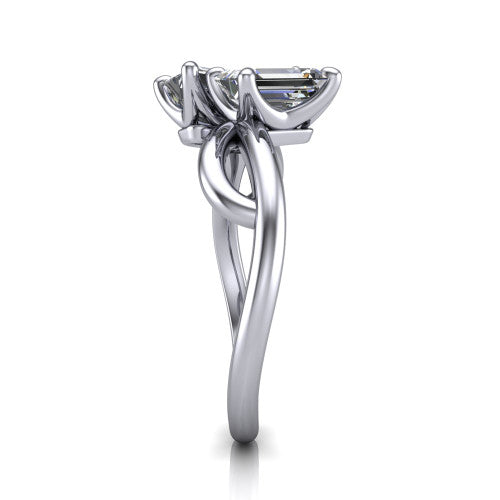 Mya emerald three stone engagement ring in 18K White Gold, side profile showing the band crossing beneath the head as a smooth polished infinity loop