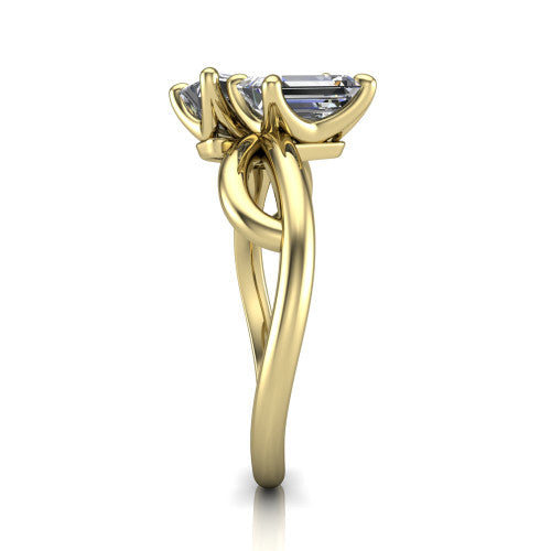 Mya emerald three stone engagement ring in 14K Yellow Gold, side profile showing the band crossing beneath the head as a smooth polished infinity loop