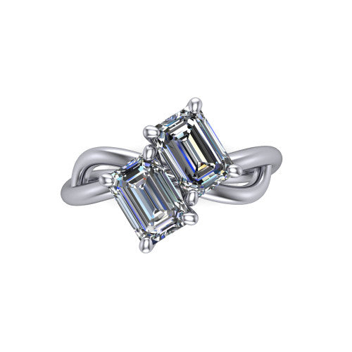 Mya emerald three stone engagement ring in 18K White Gold, top-down view showing two step-cut emerald diamonds set diagonally in a toi et moi arrangement above the infinity-loop shank