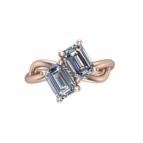 Mya emerald three stone engagement ring in 18K Rose Gold, top-down view showing two step-cut emerald diamonds set diagonally in a toi et moi arrangement above the infinity-loop shank