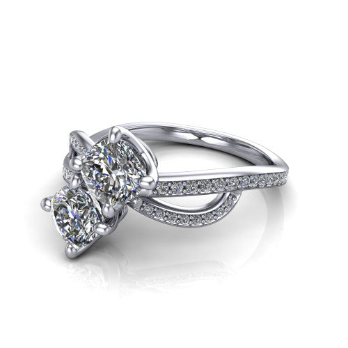 Angelina cushion three stone engagement ring in Platinum, three-quarter perspective showing two brilliant cushion-cut diamonds set diagonally on a pave infinity-loop shank