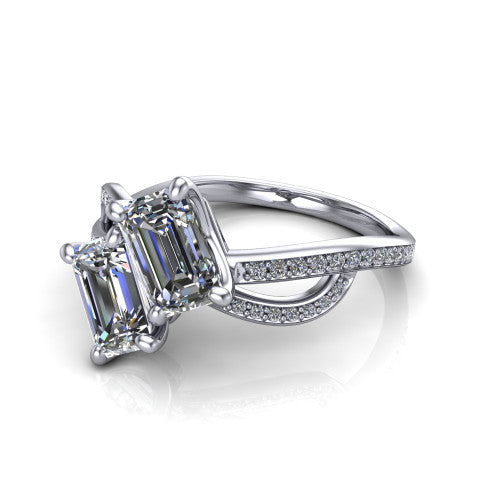 Angelina emerald three stone engagement ring in Platinum, three-quarter perspective showing two step-cut emerald diamonds set diagonally on a pave infinity-loop shank