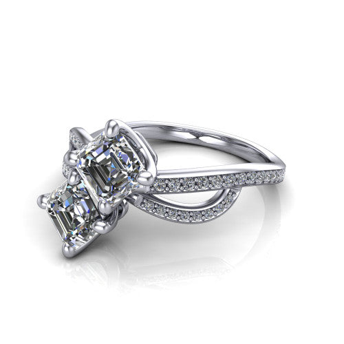 Angelina square emerald three stone engagement ring in Platinum, three-quarter perspective showing two step-cut square emerald diamonds set diagonally on a pave infinity-loop shank