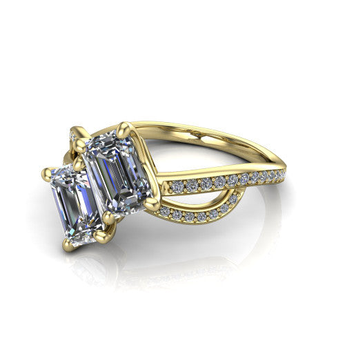 Angelina emerald three stone engagement ring in 18K Yellow Gold, three-quarter perspective showing two step-cut emerald diamonds set diagonally on a pave infinity-loop shank