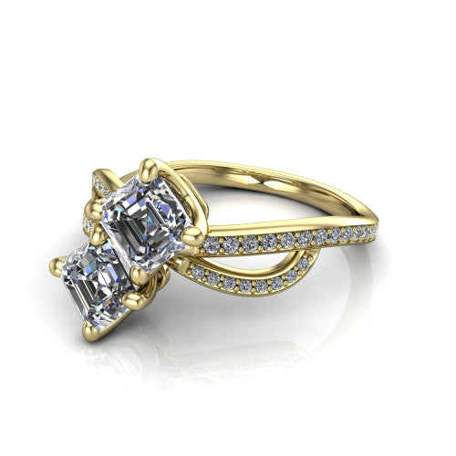 Angelina square emerald three stone engagement ring in 18K Yellow Gold, three-quarter perspective showing two step-cut square emerald diamonds set diagonally on a pave infinity-loop shank