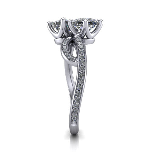 Angelina cushion three stone engagement ring in Platinum, side profile showing the band crossing beneath the head as a pave-covered infinity loop