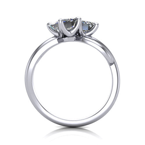 Angelina emerald three stone engagement ring in 18K White Gold, through-finger front profile showing the two-stone head and pave infinity-loop band