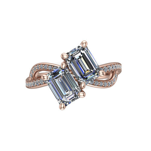 Angelina emerald three stone engagement ring in 18K Rose Gold, top-down view showing two step-cut emerald diamonds set diagonally in a toi et moi arrangement above the infinity-loop shank