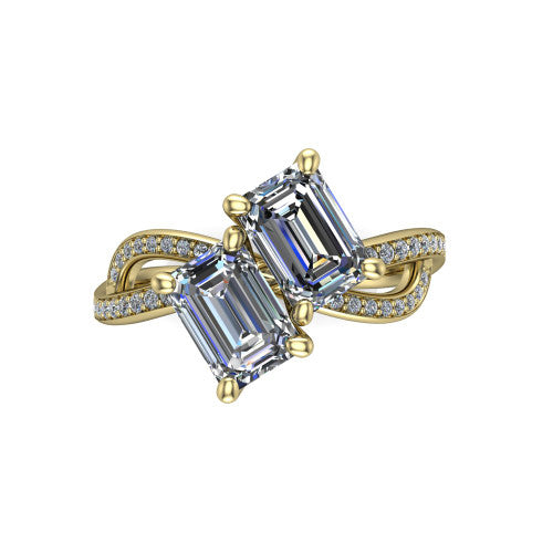 Angelina emerald three stone engagement ring in 18K Yellow Gold, top-down view showing two step-cut emerald diamonds set diagonally in a toi et moi arrangement above the infinity-loop shank