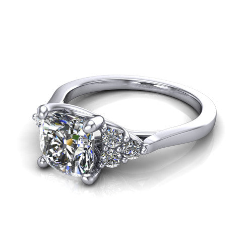 Raegan cushion three stone engagement ring in Platinum, three-quarter perspective showing the brilliant cushion-cut center diamond flanked by two triangular clusters of small round accent diamonds