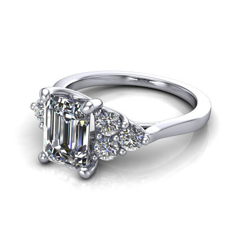 Raegan emerald three stone engagement ring in 14K White Gold, three-quarter perspective showing the step-cut emerald center diamond flanked by two triangular clusters of small round accent diamonds