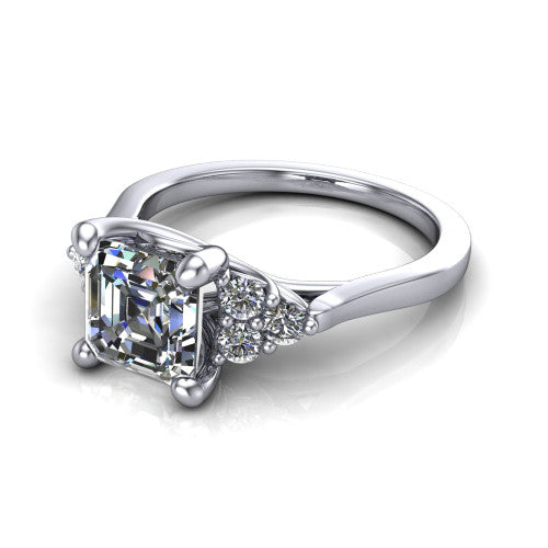 Raegan square emerald three stone engagement ring in 14K White Gold, three-quarter perspective showing the step-cut square emerald center diamond flanked by two triangular clusters of small round accent diamonds