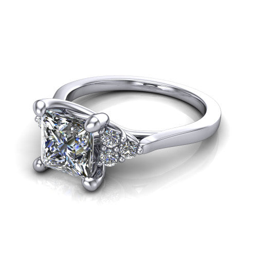 Raegan princess three stone engagement ring in 18K White Gold, three-quarter perspective showing the brilliant princess-cut center diamond flanked by two triangular clusters of small round accent diamonds