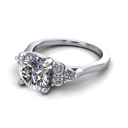 Raegan round three stone engagement ring in 18K White Gold, three-quarter perspective showing the brilliant round center diamond flanked by two triangular clusters of small round accent diamonds