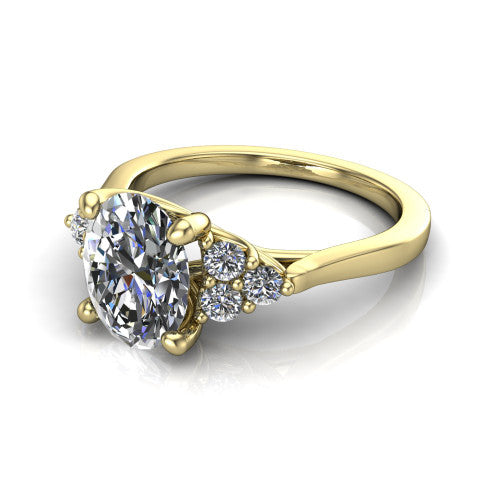 Raegan oval three stone engagement ring in 14K Yellow Gold, three-quarter perspective showing the brilliant oval center diamond flanked by two triangular clusters of small round accent diamonds