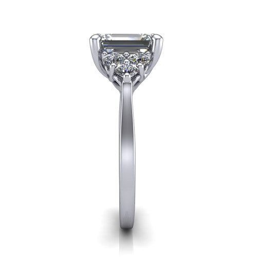 Raegan emerald three stone engagement ring in Platinum, side profile showing the cluster head, tall basket, and slim polished band
