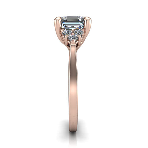 Raegan square emerald three stone engagement ring in 14K Rose Gold, side profile showing the cluster head, tall basket, and slim polished band