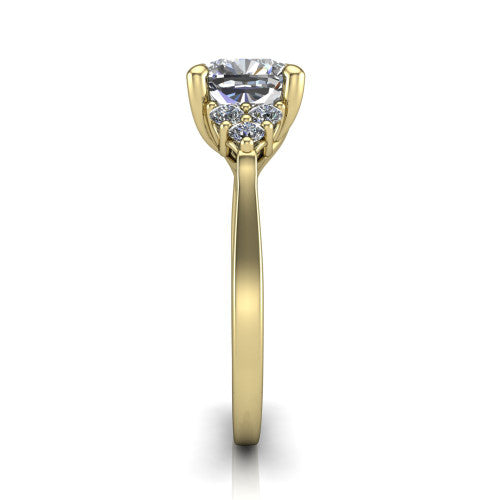 Raegan cushion three stone engagement ring in 18K Yellow Gold, side profile showing the cluster head, tall basket, and slim polished band