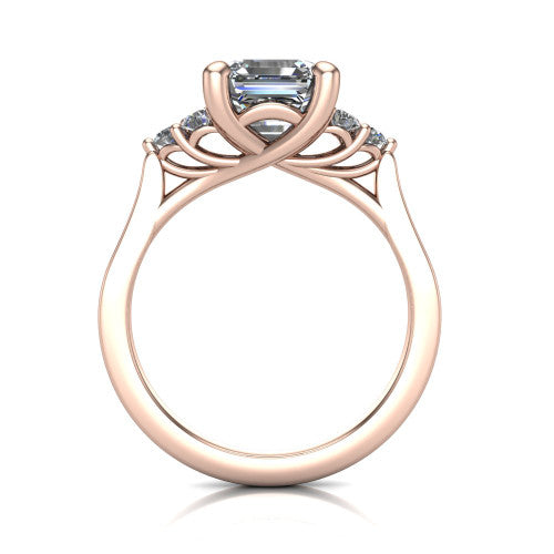 Raegan square emerald three stone engagement ring in 14K Rose Gold, through-finger front profile showing the cluster head and tall straight basket