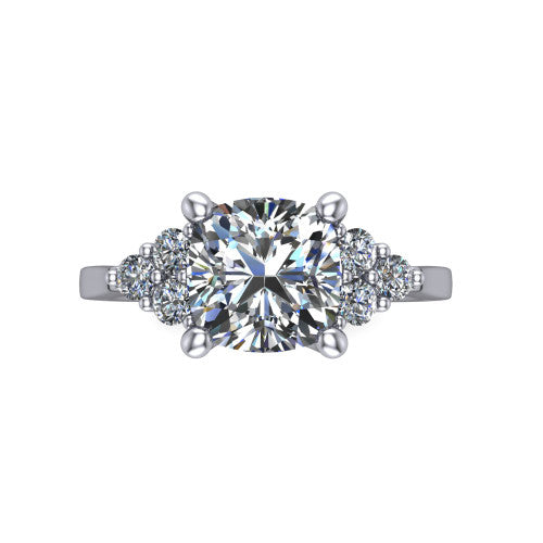 Raegan cushion three stone engagement ring in Platinum, top-down view showing the brilliant cushion-cut center diamond with triangular round-diamond clusters on each side