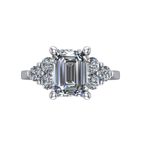 Raegan emerald three stone engagement ring in Platinum, top-down view showing the step-cut emerald center diamond with triangular round-diamond clusters on each side