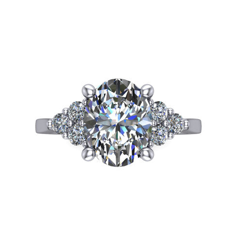 Raegan oval three stone engagement ring in 18K White Gold, top-down view showing the brilliant oval center diamond with triangular round-diamond clusters on each side