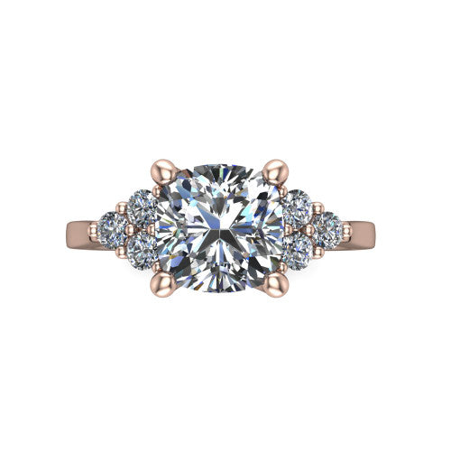 Raegan cushion three stone engagement ring in 18K Rose Gold, top-down view showing the brilliant cushion-cut center diamond with triangular round-diamond clusters on each side