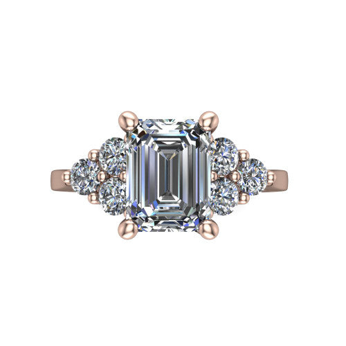 Raegan emerald three stone engagement ring in 14K Rose Gold, top-down view showing the step-cut emerald center diamond with triangular round-diamond clusters on each side