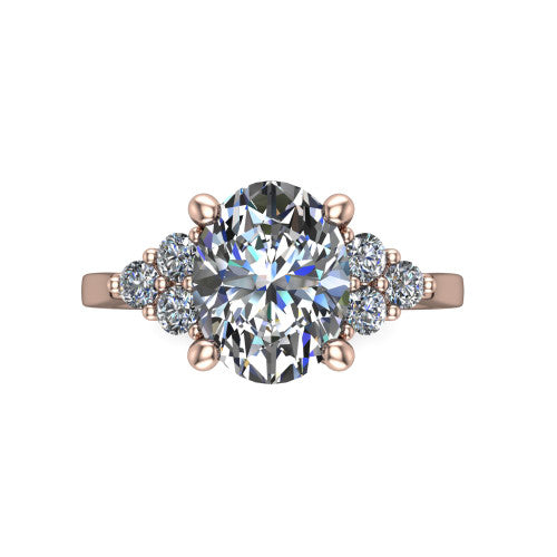 Raegan oval three stone engagement ring in 18K Rose Gold, top-down view showing the brilliant oval center diamond with triangular round-diamond clusters on each side