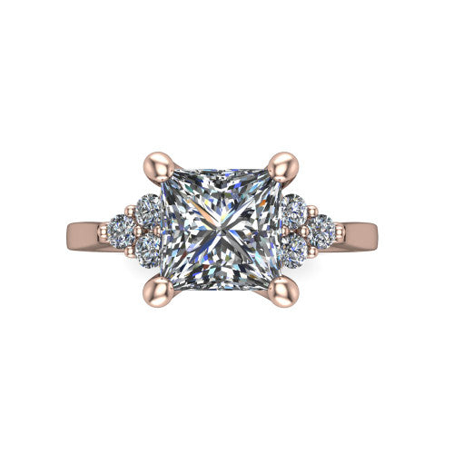 Raegan princess three stone engagement ring in 14K Rose Gold, top-down view showing the brilliant princess-cut center diamond with triangular round-diamond clusters on each side
