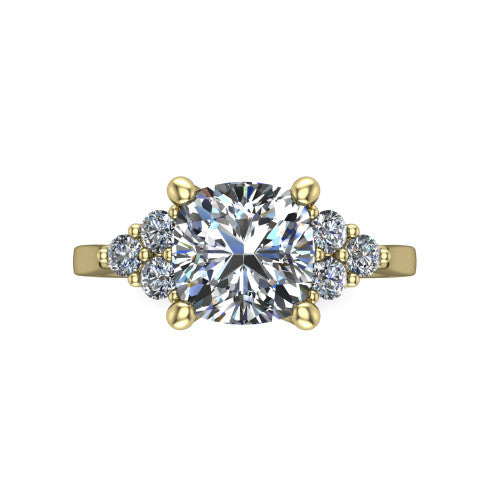 Raegan cushion three stone engagement ring in 14K Yellow Gold, top-down view showing the brilliant cushion-cut center diamond with triangular round-diamond clusters on each side