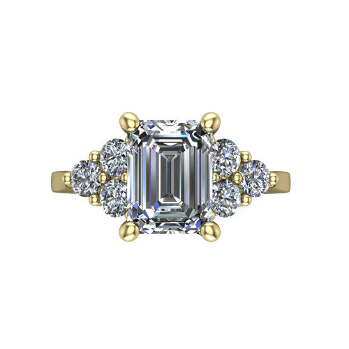 Raegan emerald three stone engagement ring in 18K Yellow Gold, top-down view showing the step-cut emerald center diamond with triangular round-diamond clusters on each side