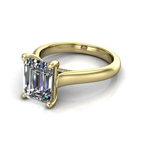 Madilyn emerald solitaire engagement ring in 18K Yellow Gold, three-quarter perspective showing the step-cut emerald center diamond on a slim polished plain band