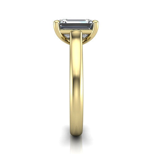 Madilyn emerald solitaire engagement ring in 18K Yellow Gold, side profile showing the hidden pave accent under the basket and slim polished plain band