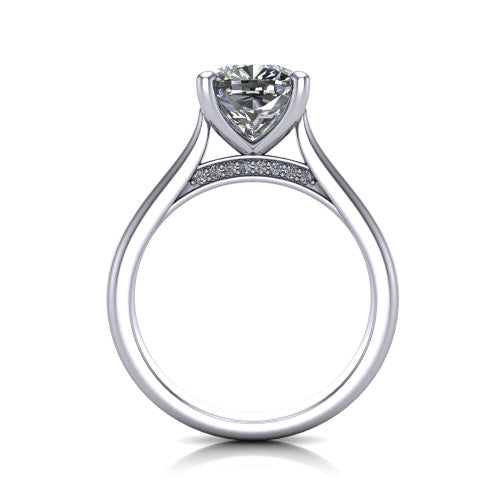 Madilyn cushion solitaire engagement ring in Platinum, through-finger front profile showing the hidden pave accent row beneath the basket and open under-gallery