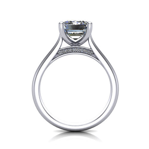 Madilyn emerald solitaire engagement ring in Platinum, through-finger front profile showing the hidden pave accent row beneath the basket and open under-gallery