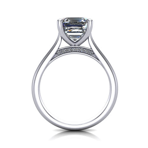 Madilyn square emerald solitaire engagement ring in 18K White Gold, through-finger front profile showing the hidden pave accent row beneath the basket and open under-gallery