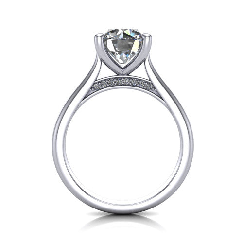 Madilyn round solitaire engagement ring in 14K White Gold, through-finger front profile showing the hidden pave accent row beneath the basket and open under-gallery