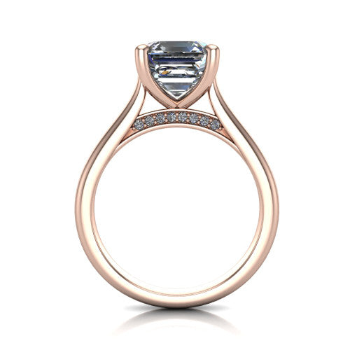 Madilyn square emerald solitaire engagement ring in 18K Rose Gold, through-finger front profile showing the hidden pave accent row beneath the basket and open under-gallery