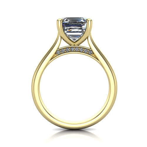 Madilyn square emerald solitaire engagement ring in 18K Yellow Gold, through-finger front profile showing the hidden pave accent row beneath the basket and open under-gallery