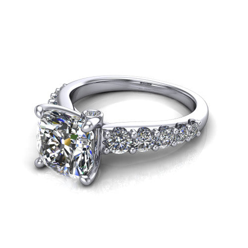 Nina cushion solitaire engagement ring in Platinum, three-quarter perspective showing the brilliant cushion-cut center diamond on a pave-accent shank with a hidden under-halo beneath the center stone