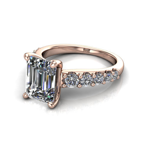 Nina emerald solitaire engagement ring in 18K Rose Gold, three-quarter perspective showing the step-cut emerald center diamond on a pave-accent shank with a hidden under-halo beneath the center stone