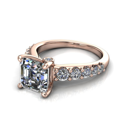 Nina square emerald solitaire engagement ring in 14K Rose Gold, three-quarter perspective showing the step-cut square emerald center diamond on a pave-accent shank with a hidden under-halo beneath the center stone
