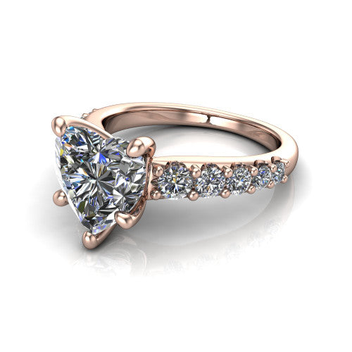Nina heart solitaire engagement ring in 14K Rose Gold, three-quarter perspective showing the brilliant heart-shaped center diamond on a pave-accent shank with a hidden under-halo beneath the center stone