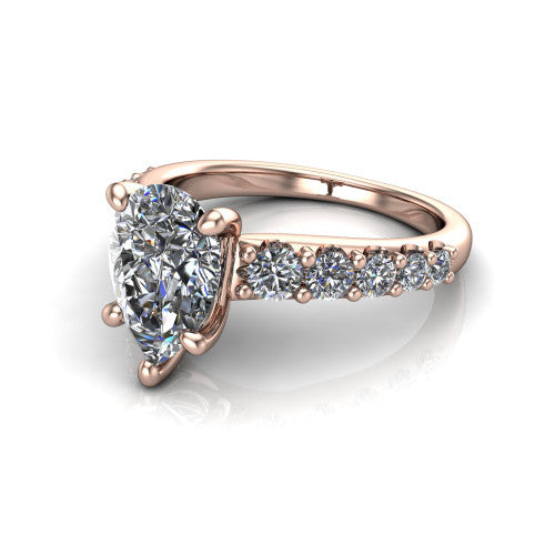 Nina pear solitaire engagement ring in 14K Rose Gold, three-quarter perspective showing the brilliant pear-cut center diamond on a pave-accent shank with a hidden under-halo beneath the center stone